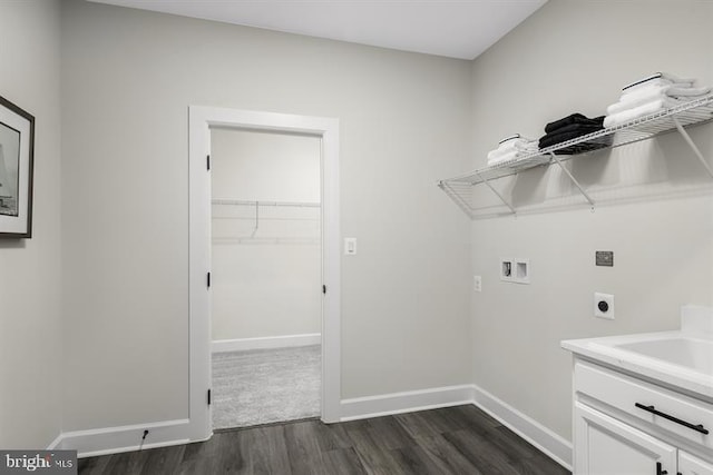 washroom featuring hookup for a washing machine, dark hardwood / wood-style floors, and electric dryer hookup