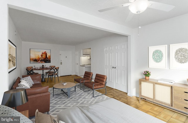 living room with parquet floors and ceiling fan