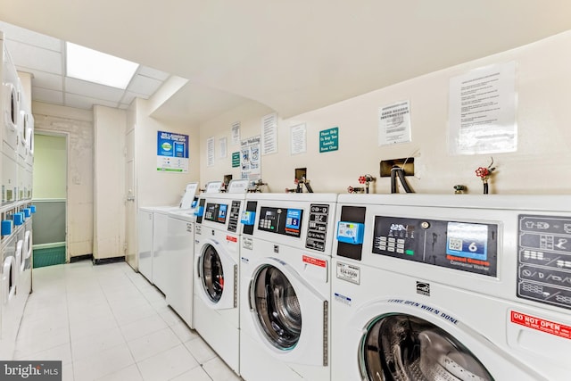 laundry room with washer and clothes dryer, light tile patterned flooring, and stacked washer / drying machine