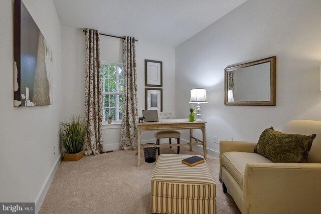 sitting room with vaulted ceiling and carpet floors