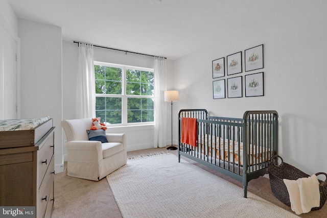 carpeted bedroom featuring a crib