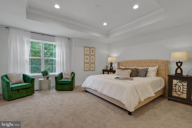 bedroom with carpet, a tray ceiling, and crown molding