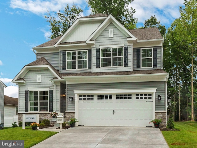 craftsman house featuring a garage and a front lawn