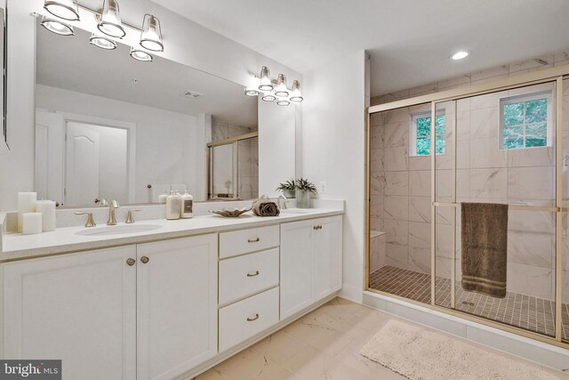 bathroom featuring vanity and an enclosed shower