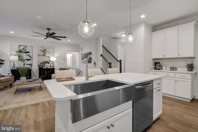 kitchen featuring ceiling fan, white cabinets, light hardwood / wood-style floors, and stainless steel dishwasher