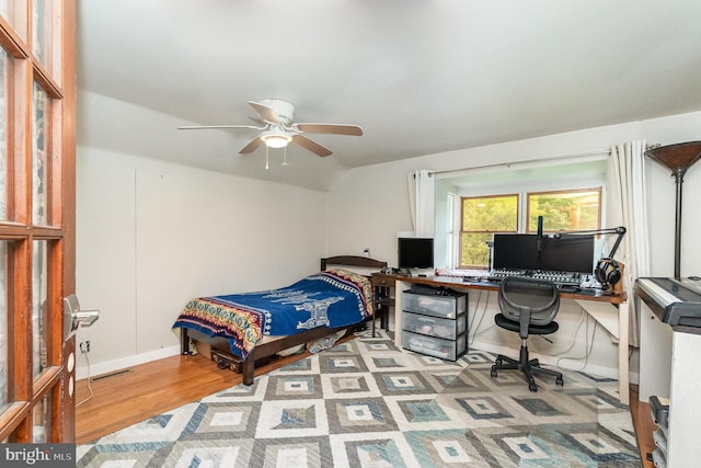 bedroom featuring ceiling fan, vaulted ceiling, and light hardwood / wood-style floors