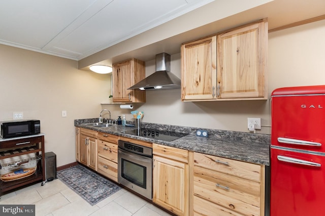 kitchen featuring light tile patterned floors, black appliances, crown molding, sink, and wall chimney range hood