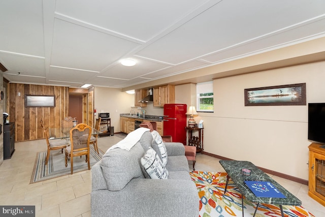 living room with light tile patterned flooring and wooden walls