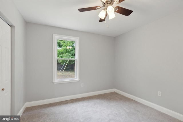 carpeted empty room with ceiling fan