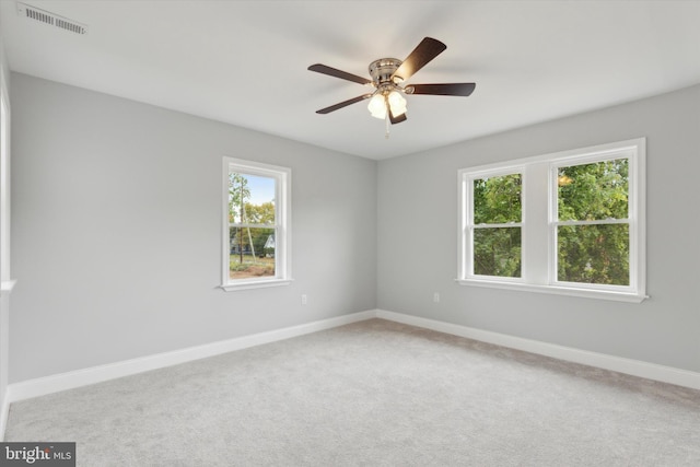 carpeted spare room with ceiling fan