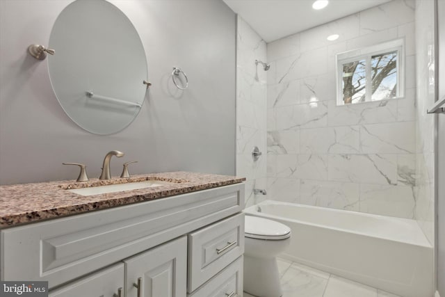 full bathroom with vanity, tiled shower / bath, and toilet