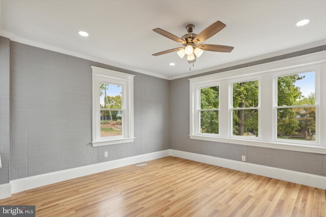 spare room with ceiling fan, crown molding, and hardwood / wood-style floors