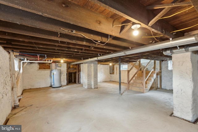 basement featuring water heater and electric panel