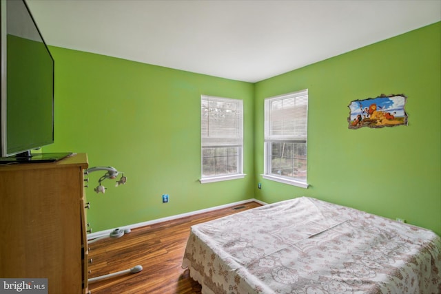 bedroom with dark wood-type flooring