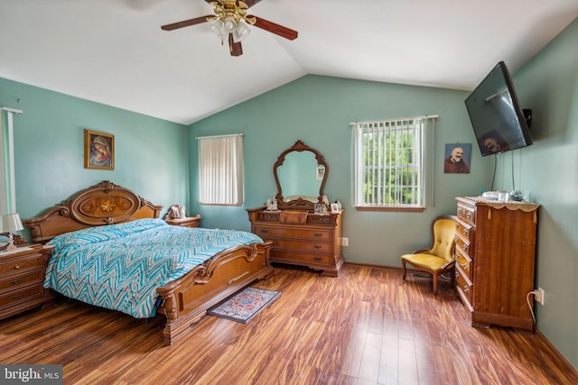 bedroom featuring wood-type flooring, vaulted ceiling, and ceiling fan