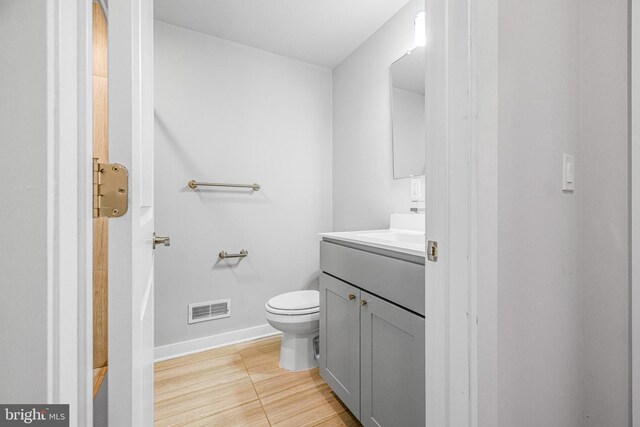 bathroom featuring toilet, vanity, and tile patterned flooring