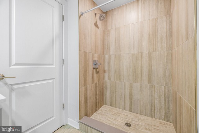 bathroom with a tile shower