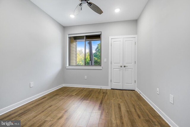 unfurnished room featuring ceiling fan and dark hardwood / wood-style floors