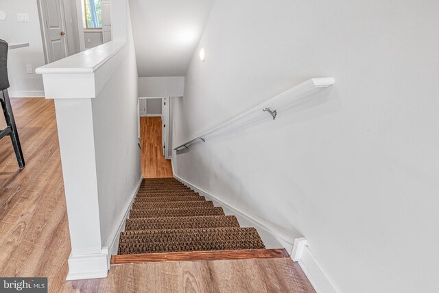 stairs with hardwood / wood-style floors