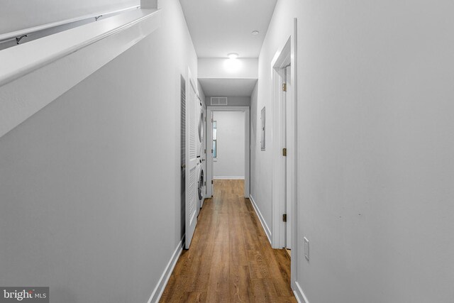 hallway with hardwood / wood-style floors