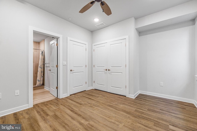 unfurnished bedroom with ceiling fan and wood-type flooring