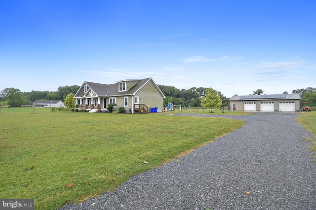 view of front of property featuring a garage, a porch, and a front lawn