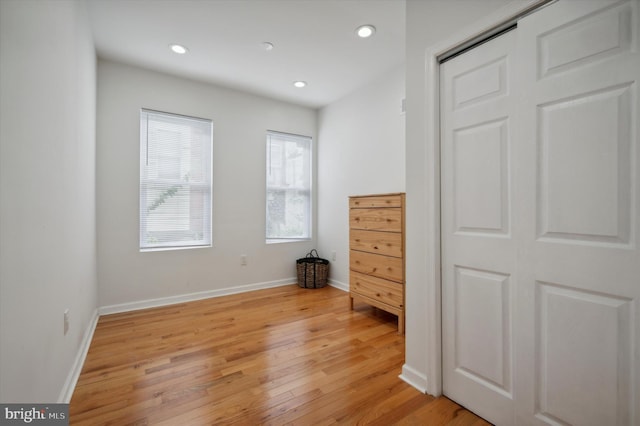 unfurnished bedroom featuring baseboards, recessed lighting, and light wood finished floors