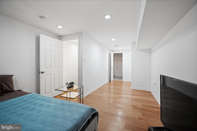 bedroom with light wood-style flooring, baseboards, and recessed lighting