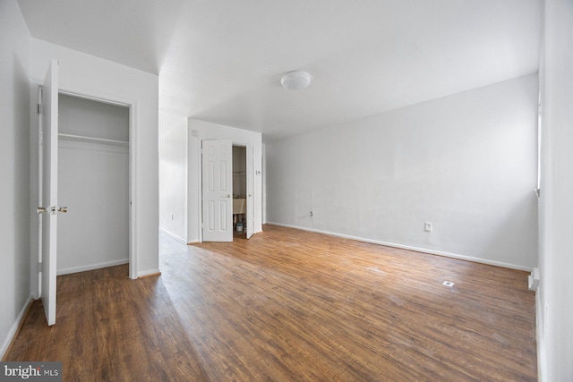 unfurnished bedroom with dark hardwood / wood-style flooring