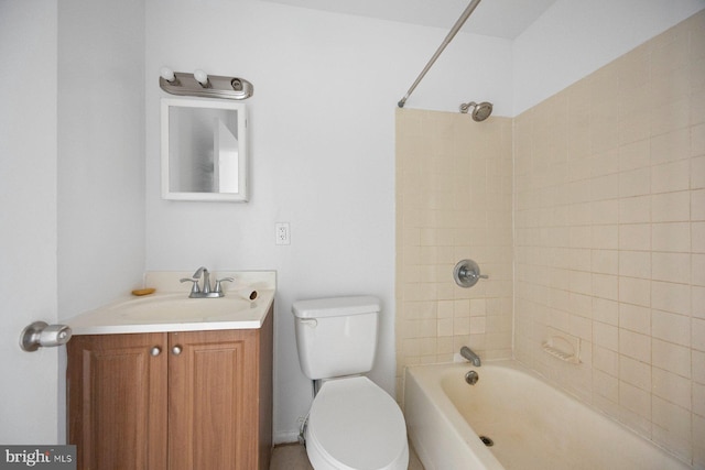 full bathroom featuring vanity, tiled shower / bath combo, and toilet