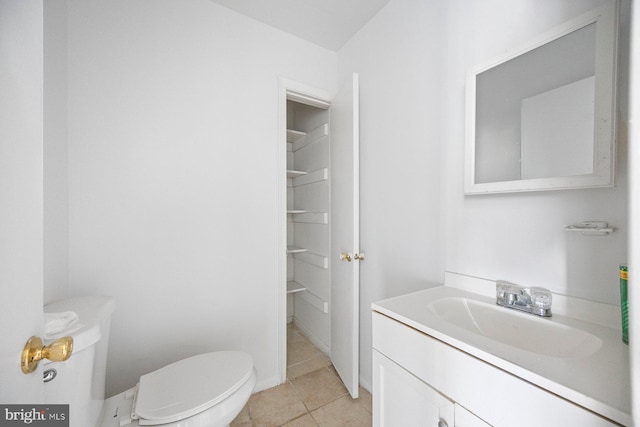 bathroom with vanity, toilet, and tile patterned floors