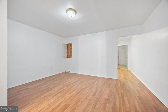 unfurnished room with light wood-type flooring