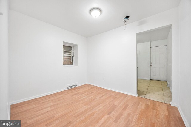 spare room with light hardwood / wood-style flooring