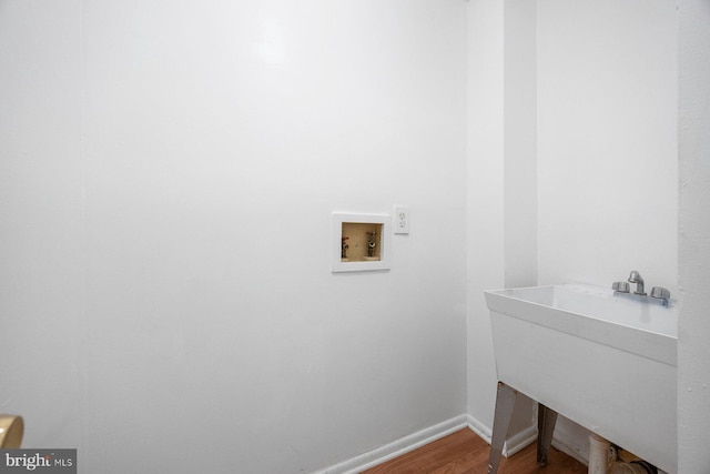 clothes washing area with washer hookup, hardwood / wood-style floors, and sink