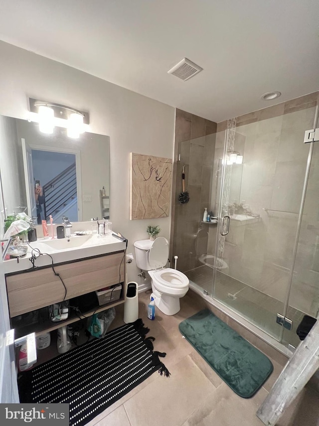 bathroom with walk in shower, vanity, and toilet