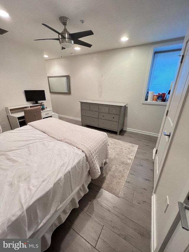 bedroom with ceiling fan and dark hardwood / wood-style floors