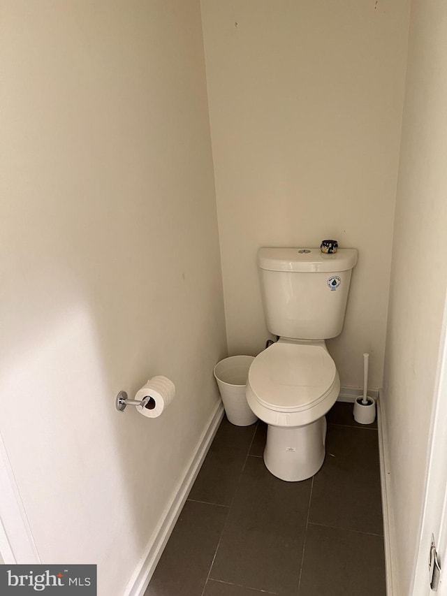 bathroom with toilet and tile patterned floors