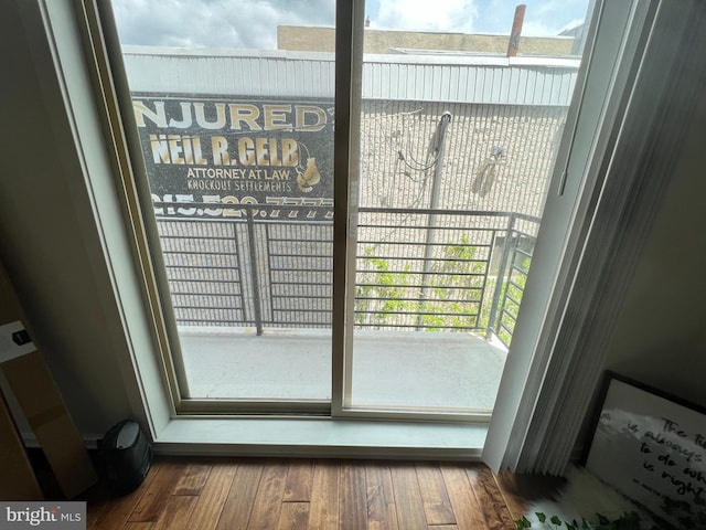 doorway to outside with a healthy amount of sunlight and dark hardwood / wood-style floors