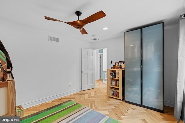 bedroom featuring ceiling fan and light parquet flooring