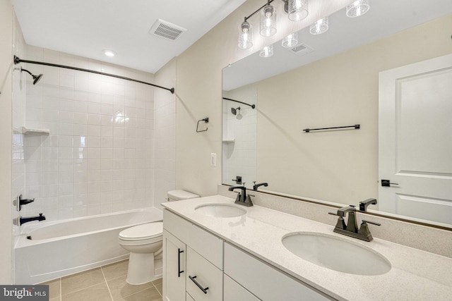 full bathroom with toilet, tiled shower / bath, vanity, and tile patterned floors