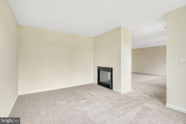 118 Pawn Ct, Winchester, VA 22602 - unfurnished living room featuring a glass covered fireplace, carpet floors, and baseboards