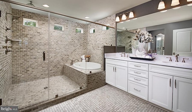 bathroom featuring double vanity, a shower stall, a garden tub, and a sink