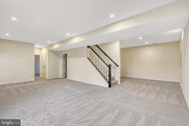 basement featuring light carpet