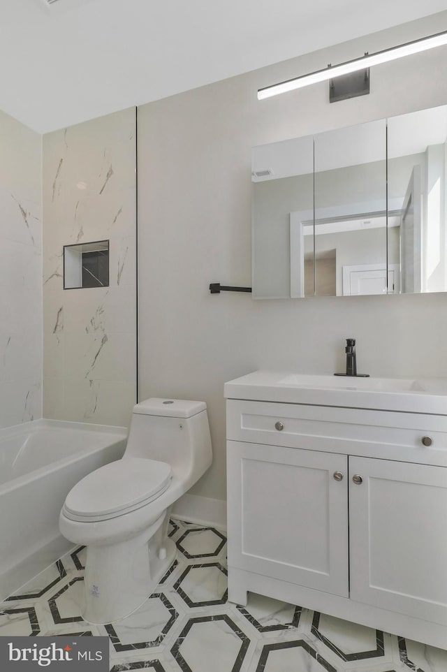 full bathroom featuring tiled shower / bath combo, vanity, toilet, and tile patterned floors