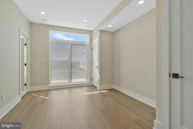 spare room featuring light hardwood / wood-style flooring