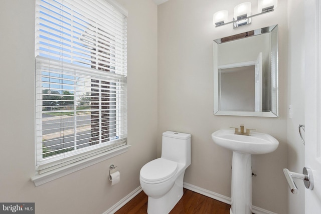 bathroom with wood-type flooring and toilet