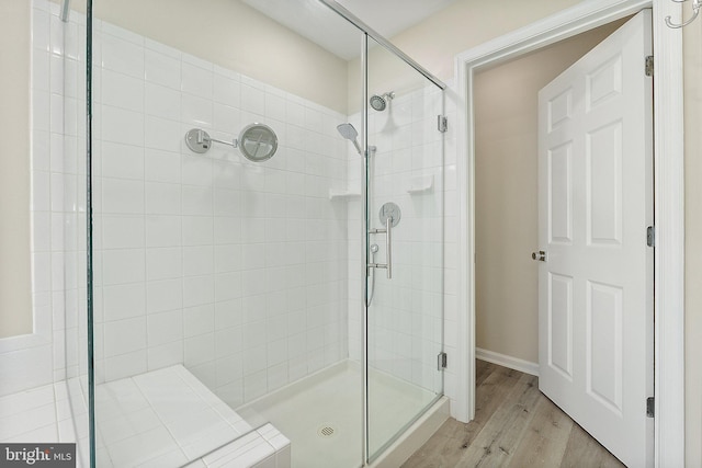 bathroom featuring walk in shower and hardwood / wood-style flooring