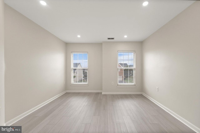 unfurnished room featuring light hardwood / wood-style flooring and a wealth of natural light