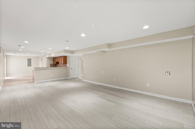 unfurnished living room featuring light hardwood / wood-style floors and electric panel