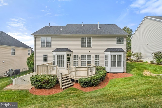 back of house featuring a deck and a yard